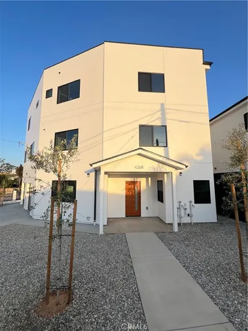 a view of a white building with large windows