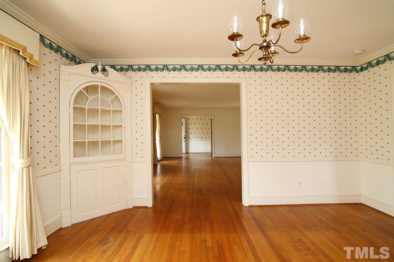 516 Chesterfield Road Raleigh, NC 27608 - Photo 6 of 21 a view of a room with wooden floor and a chandelier