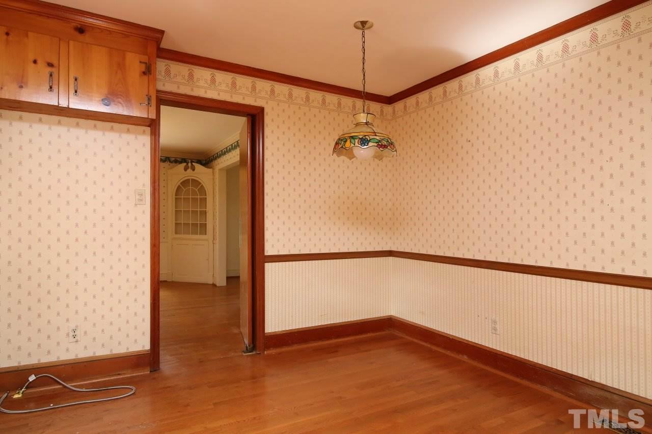 516 Chesterfield Road Raleigh, NC 27608 - Photo 10 of 21 a view of empty room with wooden floor and fan