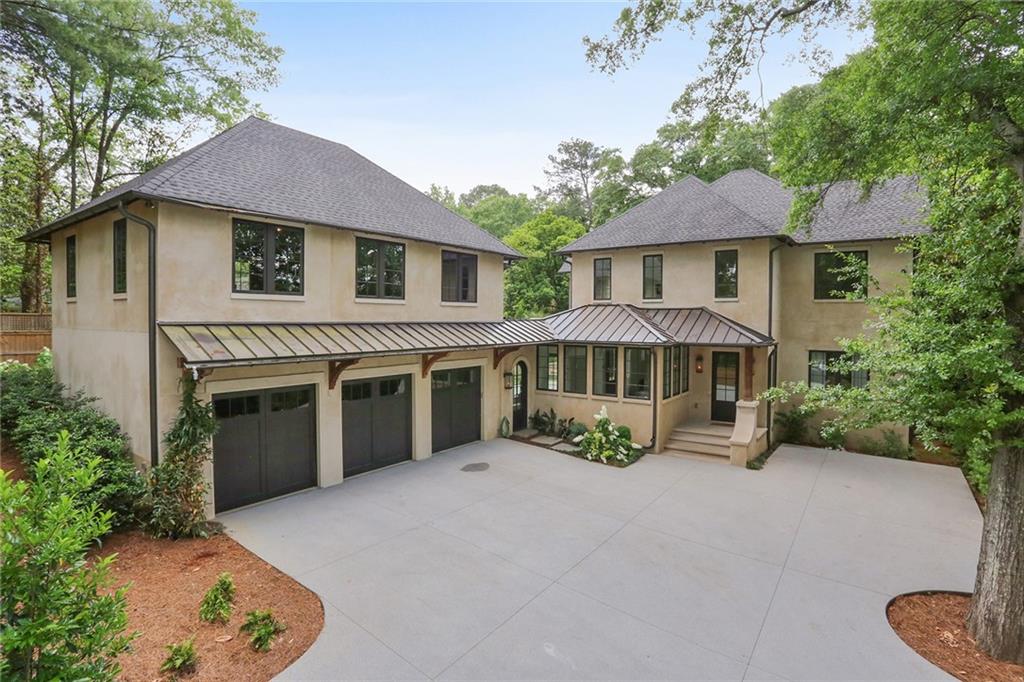 a view of a house with a yard and sitting area
