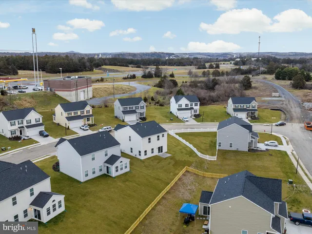 an aerial view of a swimming pool with outdoor seating