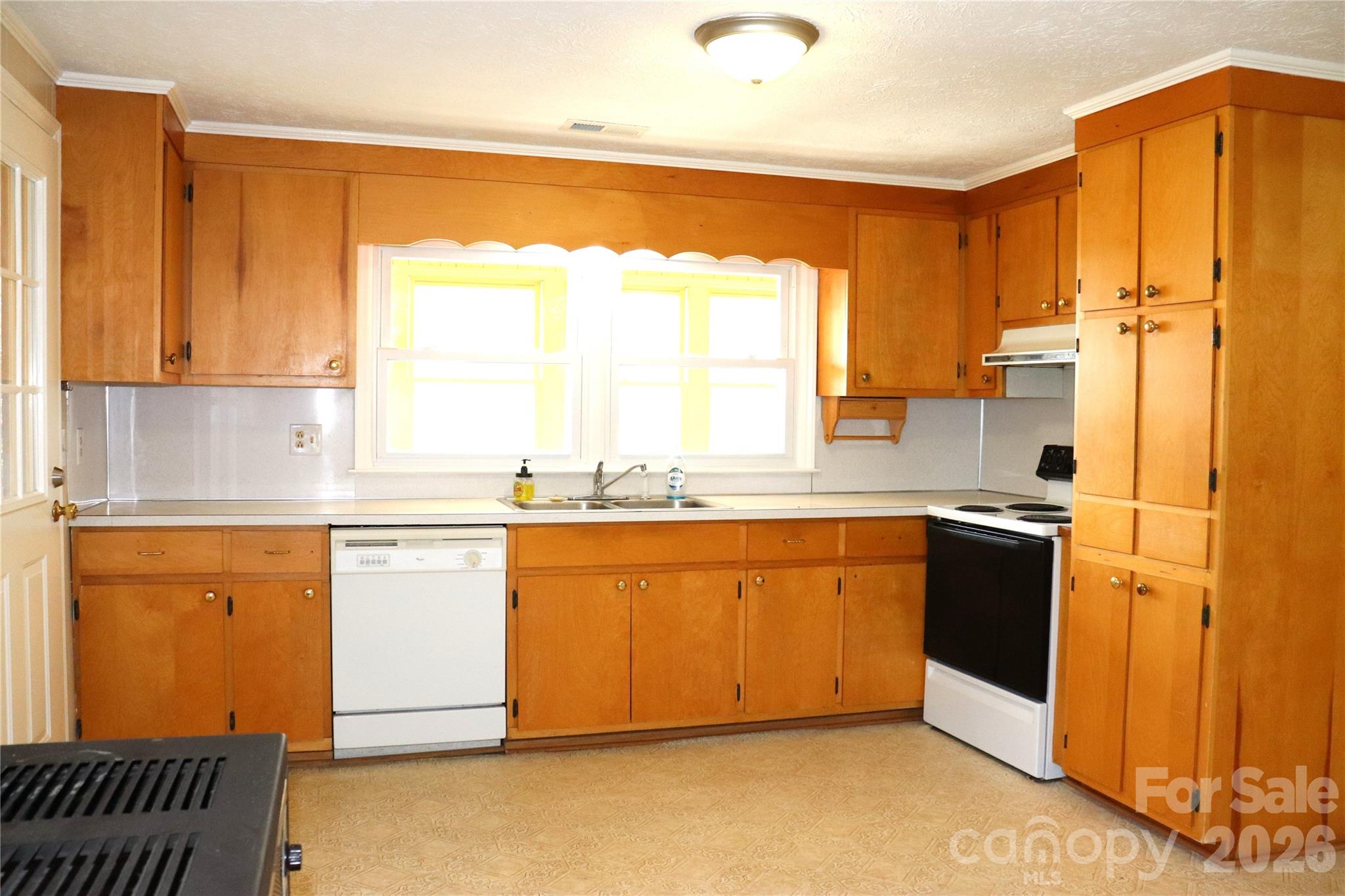 4543 Horseshoe Bend Road Hudson, NC 28638 - Photo 12 of 38 a kitchen with stainless steel appliances granite countertop a refrigerator a sink dishwasher and white cabinets with wooden floor