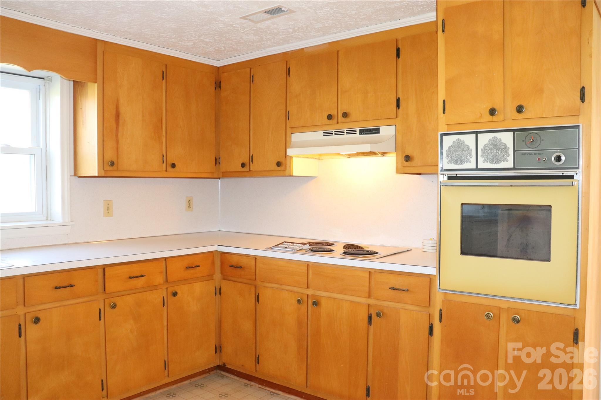 4543 Horseshoe Bend Road Hudson, NC 28638 - Photo 27 of 38 a kitchen with stainless steel appliances granite countertop a stove a sink and white cabinets with wooden floor