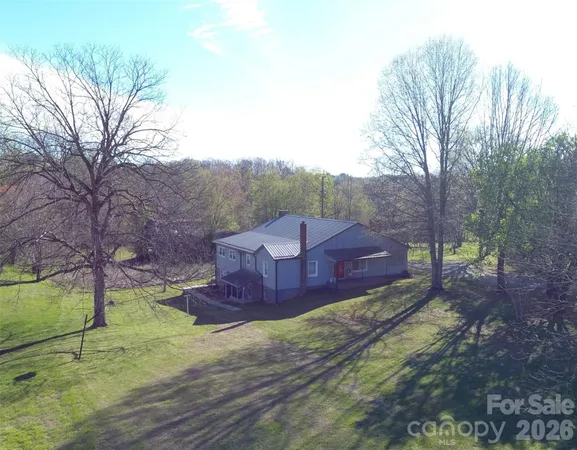 a view of a big yard with large trees