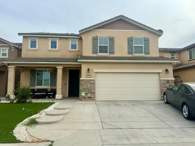 a front view of a house with a yard and garage