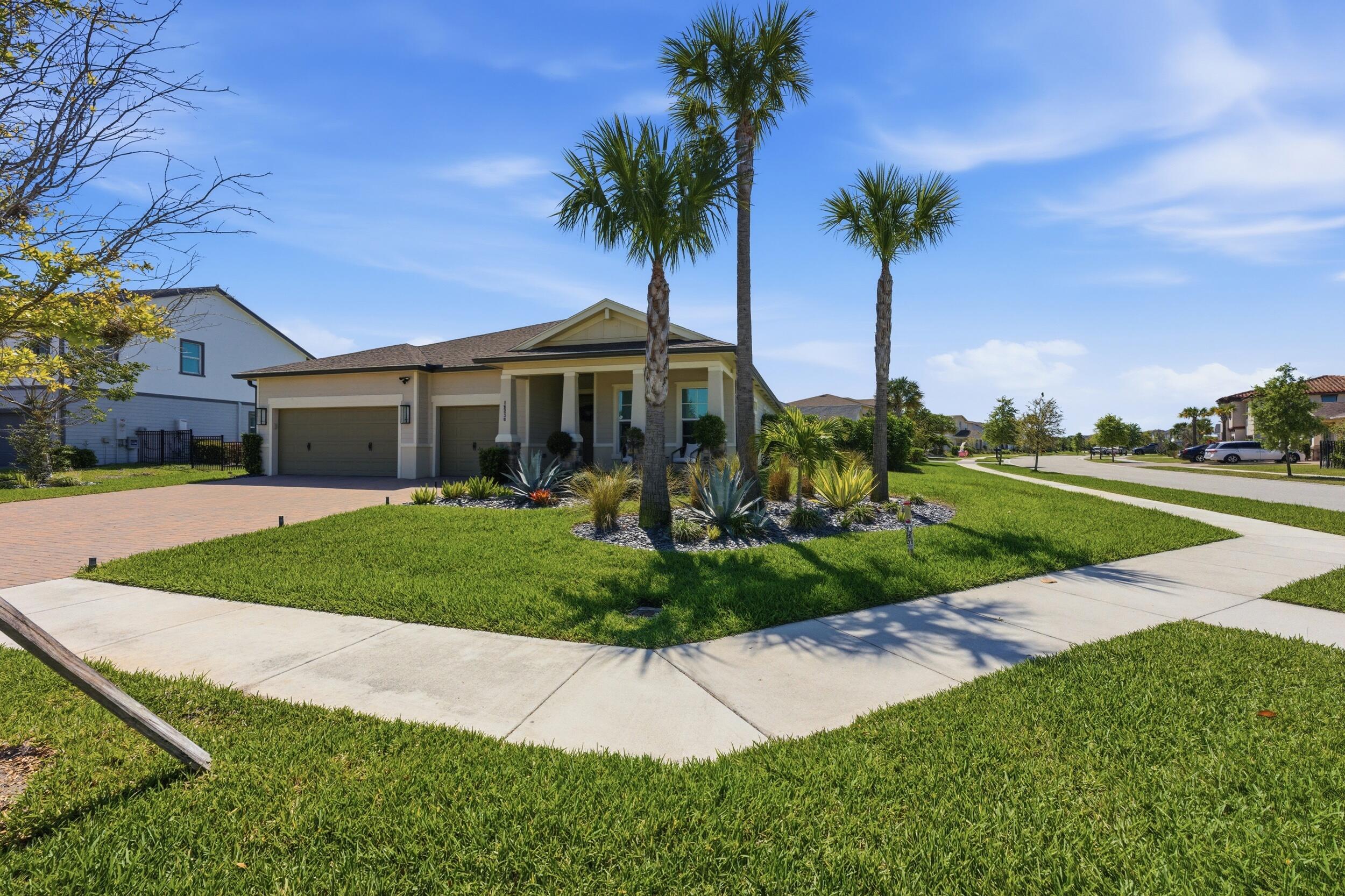 19230 Rolling Acres Road Loxahatchee, FL 33470 - Photo 39 of 58 a front view of a house with garden