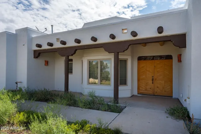 a front view of a house with plants