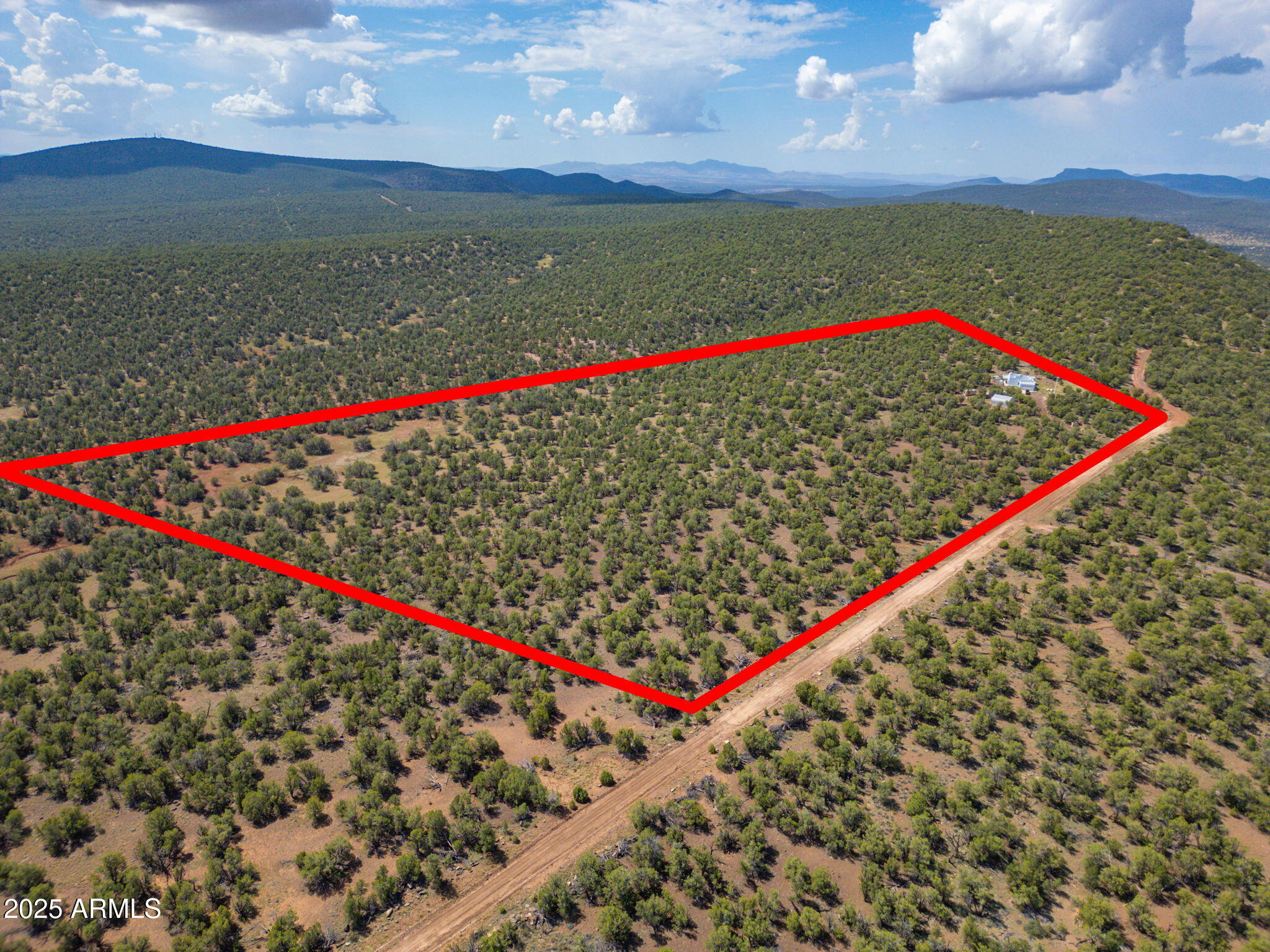 35575 West Pale Moon Road Seligman, AZ 86337 - Photo 34 of 45 a view of a small yard and a wooden bench