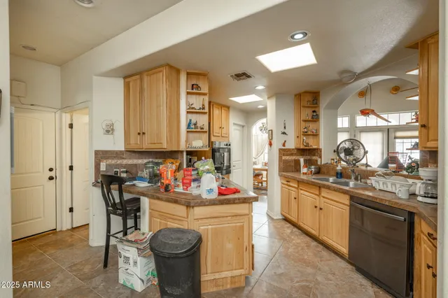 a kitchen with stainless steel appliances kitchen island granite countertop a sink and cabinets