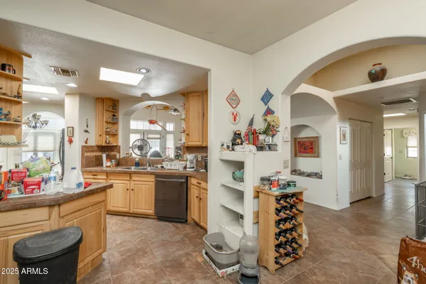 a kitchen with stainless steel appliances kitchen island granite countertop a refrigerator and stove