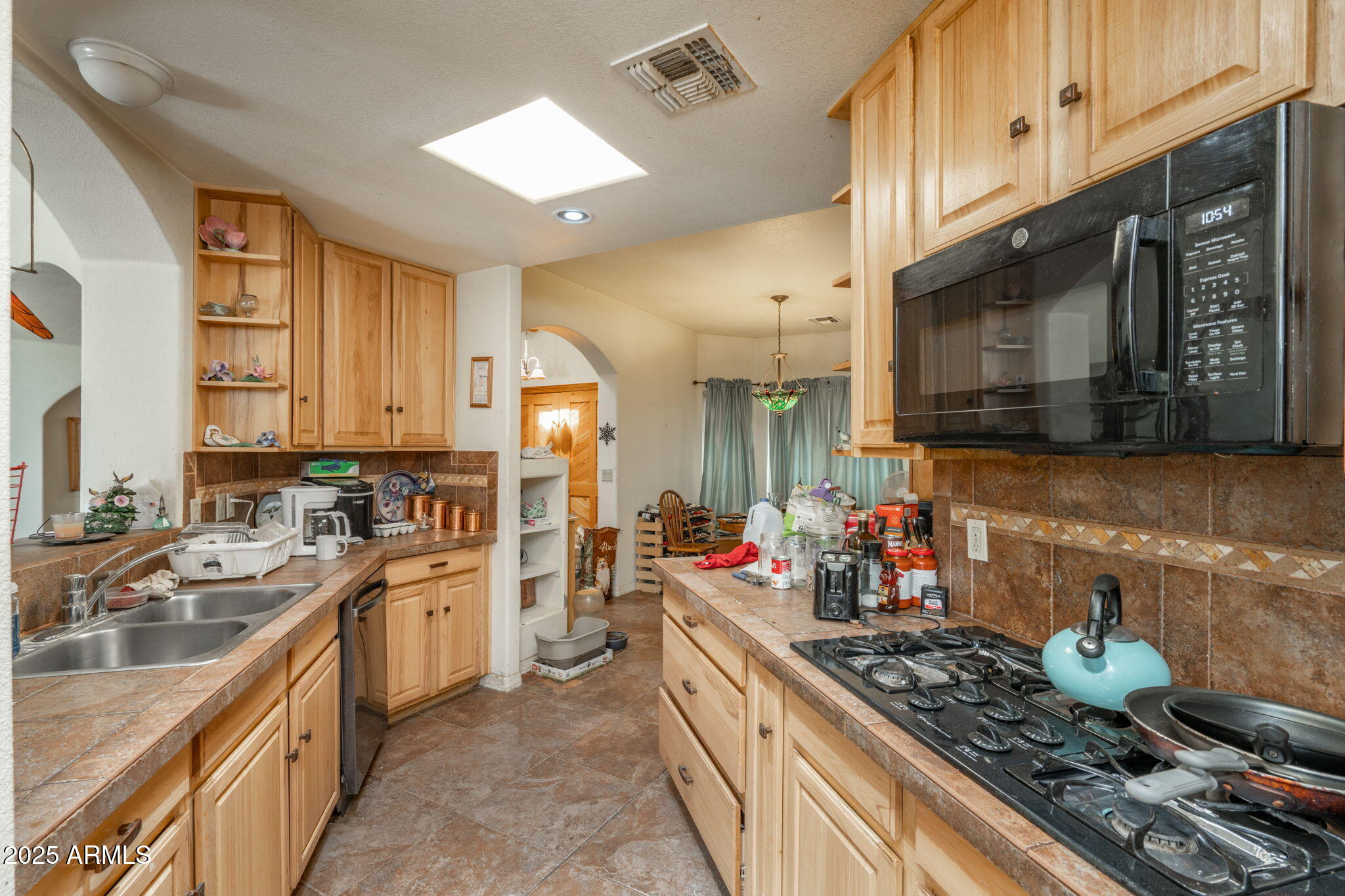 35575 West Pale Moon Road Seligman, AZ 86337 - Photo 10 of 45 a kitchen with stainless steel appliances kitchen island granite countertop a sink stove and cabinets