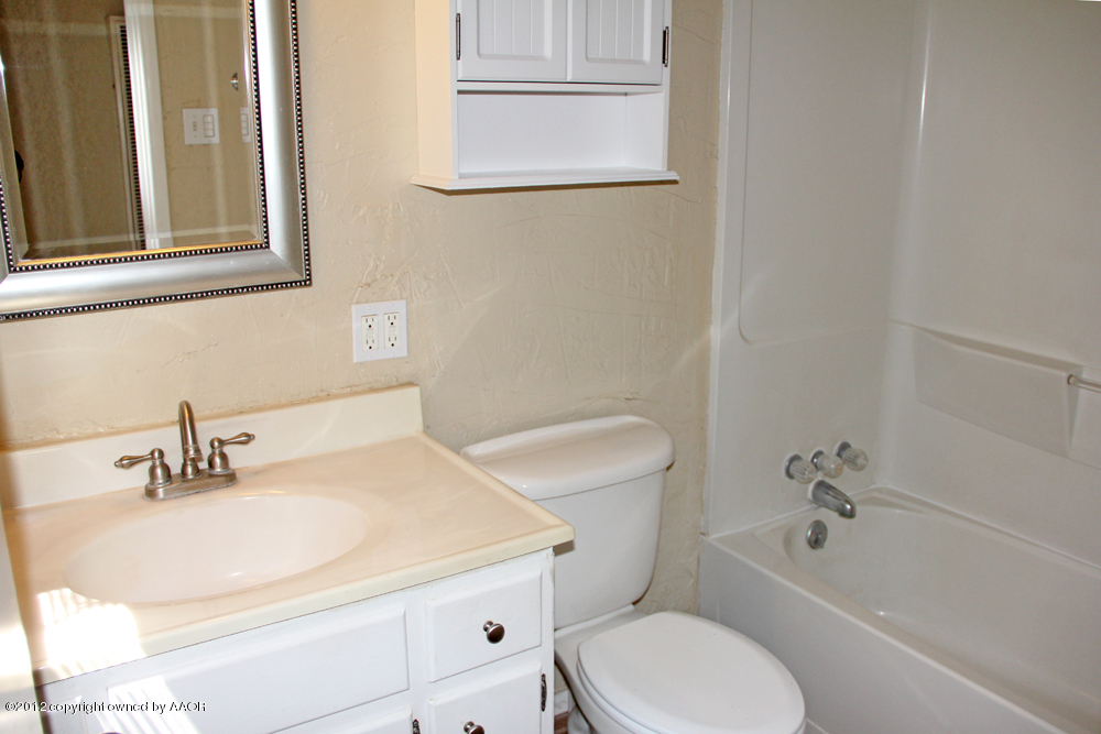 4306 South Hayden Street Amarillo, TX 79110 - Photo 18 of 23 a bathroom with a sink a toilet and shower