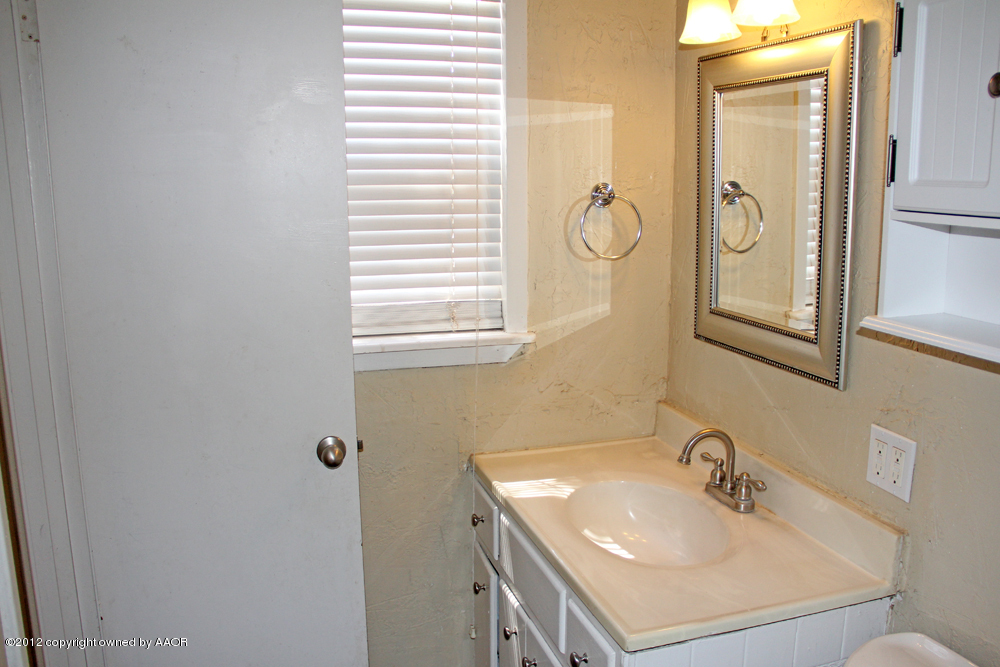 4306 South Hayden Street Amarillo, TX 79110 - Photo 19 of 23 a bathroom with a sink and a mirror