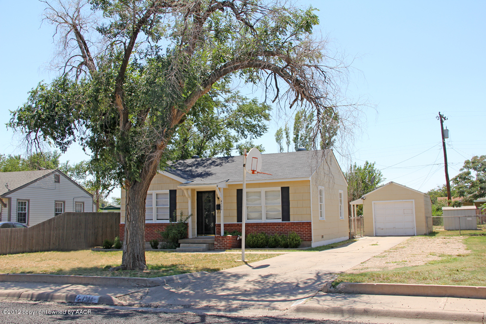 4306 South Hayden Street Amarillo, TX 79110 - Photo 2 of 23 a view of a house with a yard covered in snow