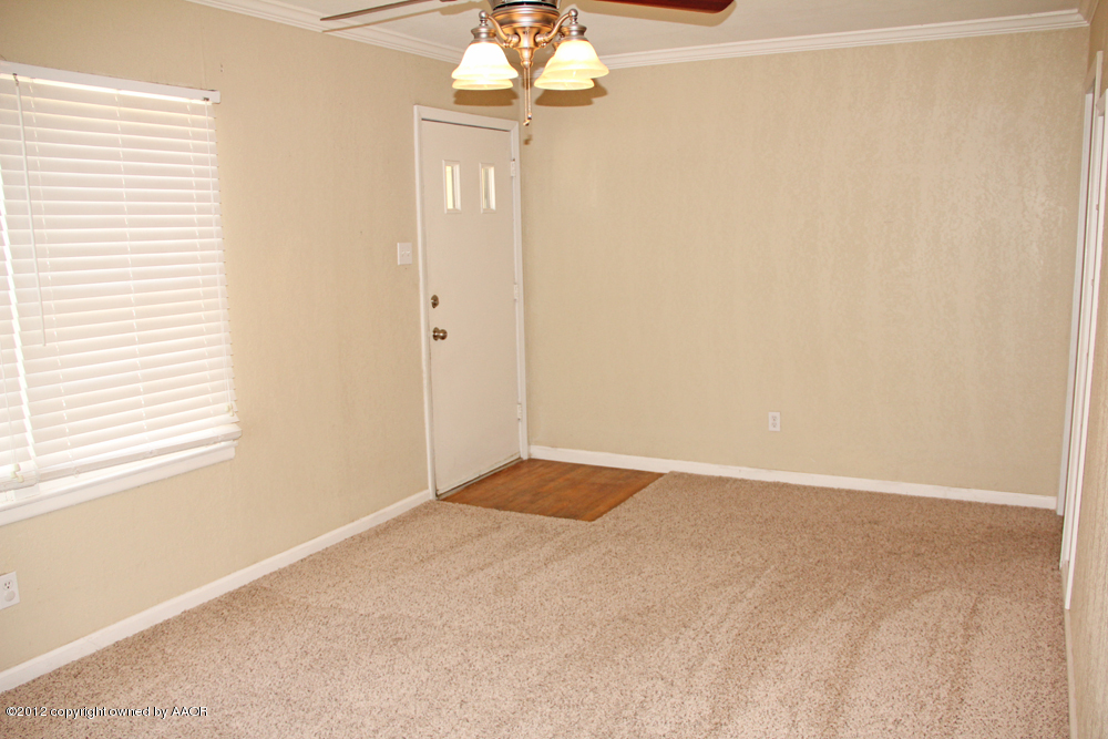 4306 South Hayden Street Amarillo, TX 79110 - Photo 4 of 23 a view of an empty room with a window
