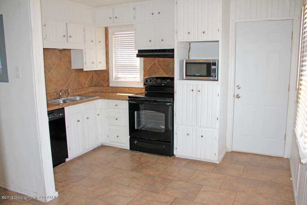 4306 South Hayden Street Amarillo, TX 79110 - Photo 8 of 23 a kitchen with white cabinets and appliances