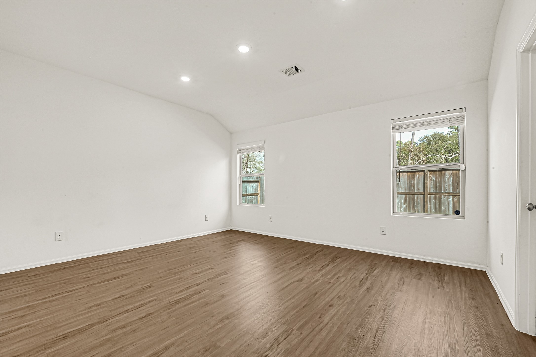 2010 Ballesteros Street Crosby, TX 77532 - Photo 11 of 24 an empty room with wooden floor and windows