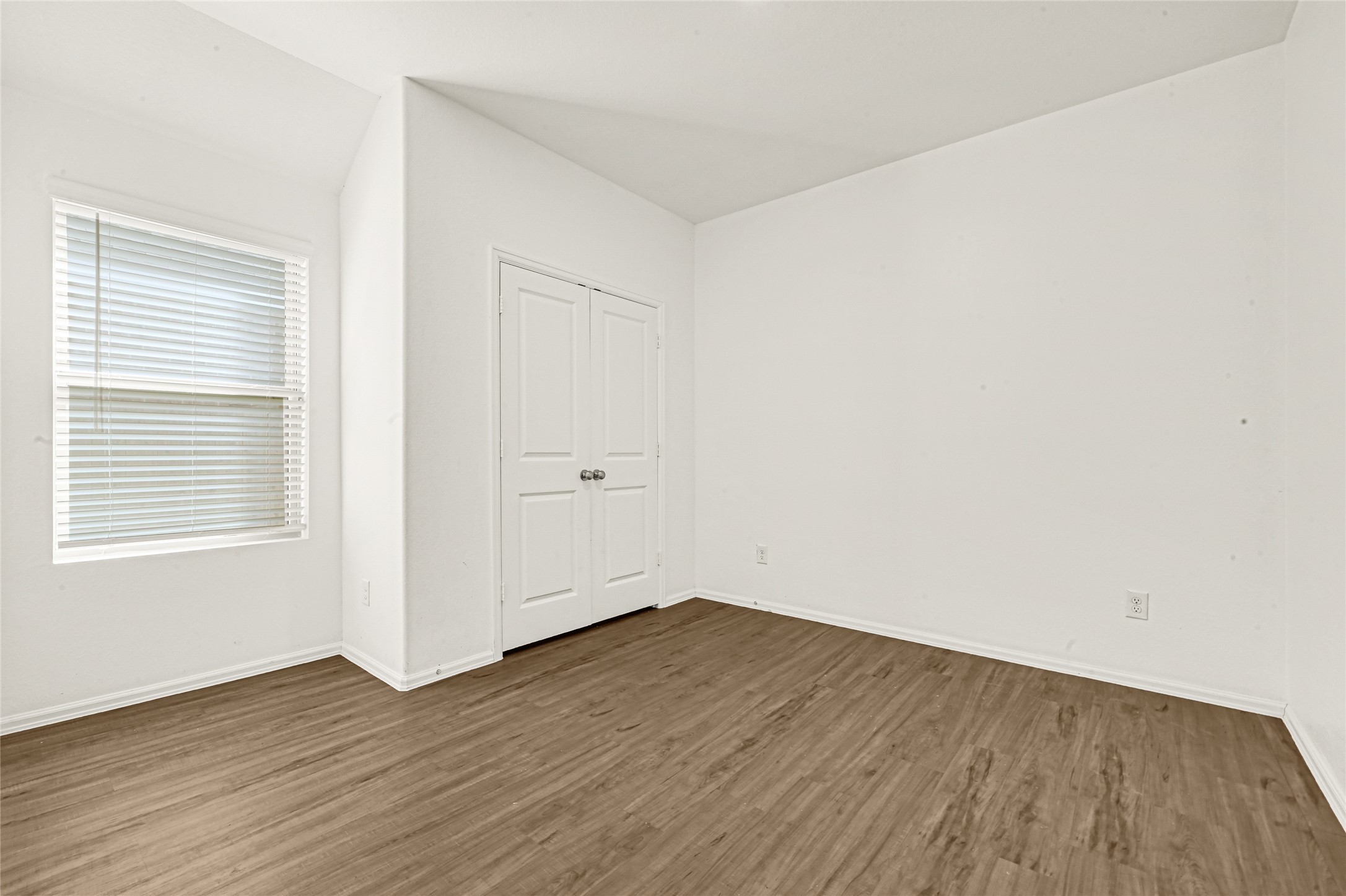 2010 Ballesteros Street Crosby, TX 77532 - Photo 16 of 24 an empty room with wooden floor and windows