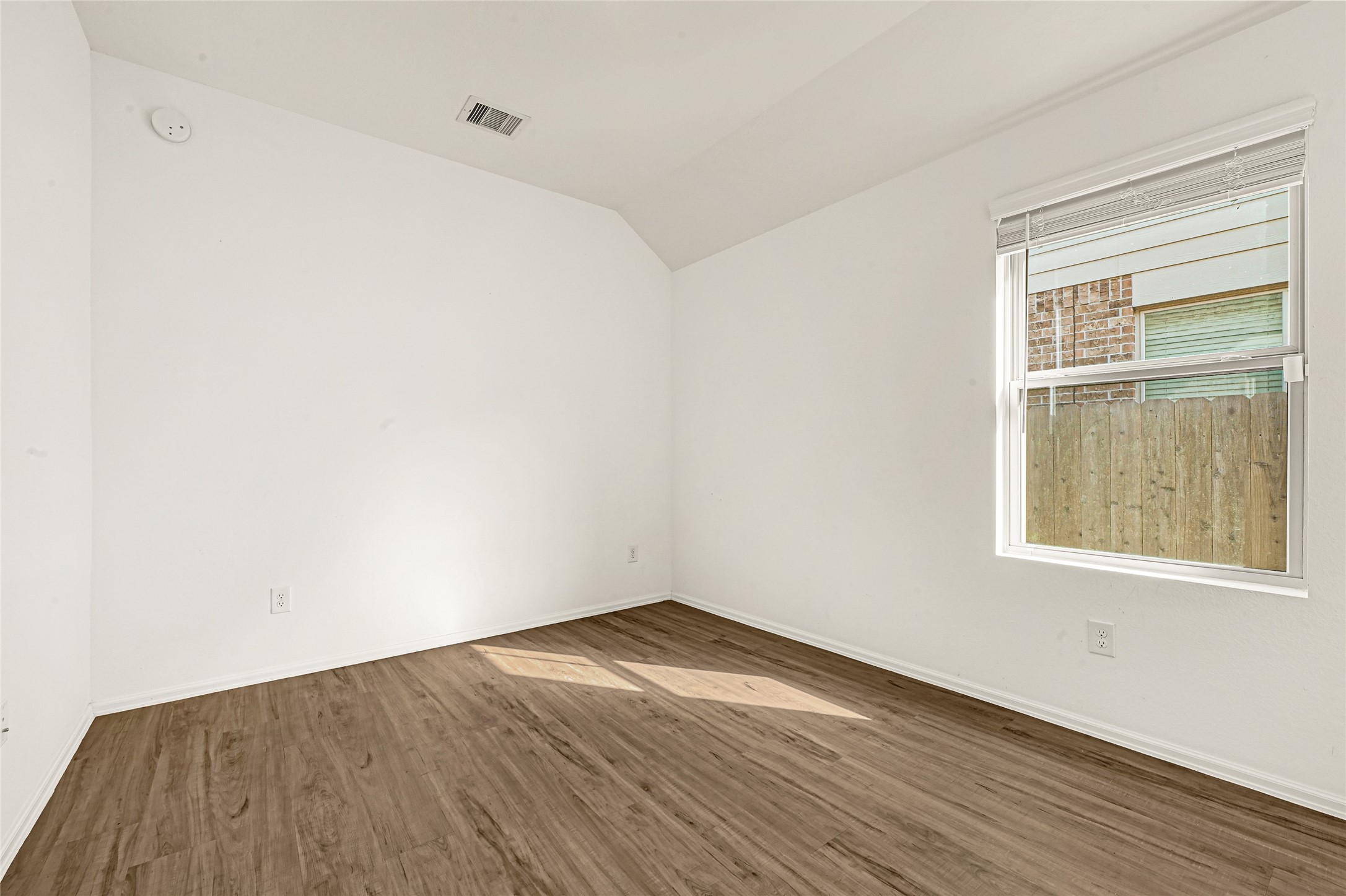 2010 Ballesteros Street Crosby, TX 77532 - Photo 19 of 24 an empty room with wooden floor and windows