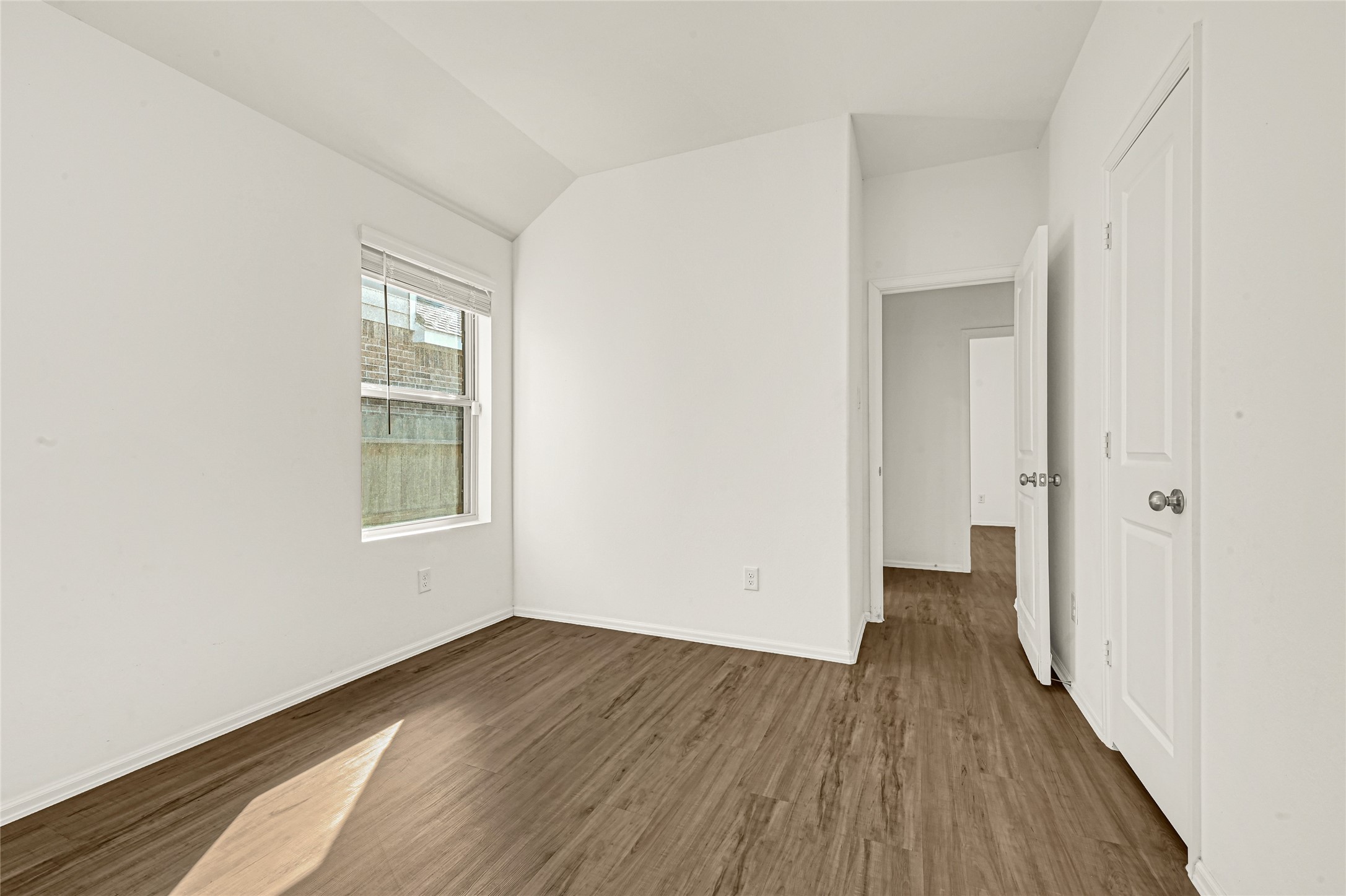 2010 Ballesteros Street Crosby, TX 77532 - Photo 20 of 24 an empty room with wooden floor and windows