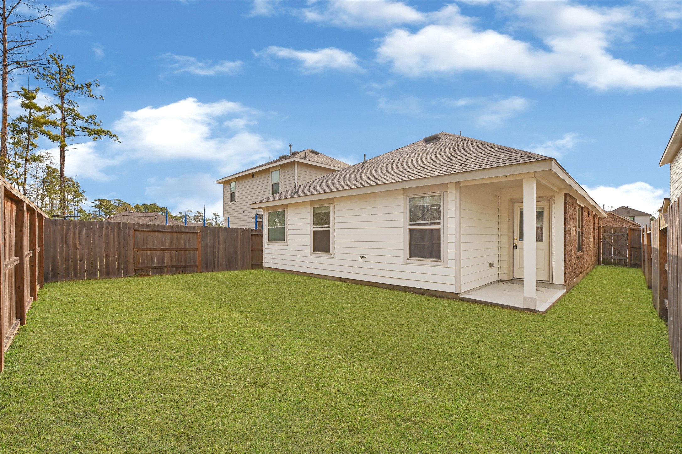 2010 Ballesteros Street Crosby, TX 77532 - Photo 22 of 24 a big house with a yard and wooden fence