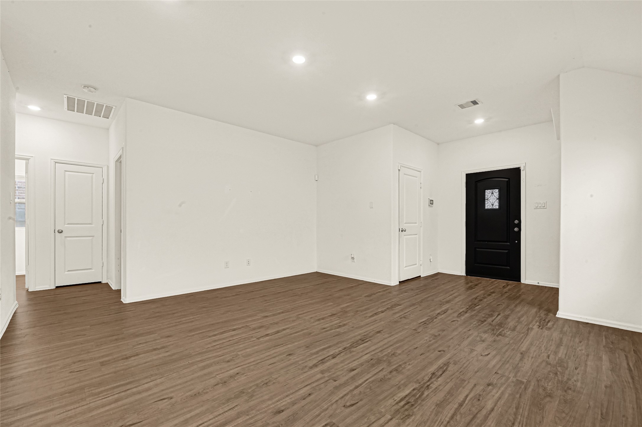 2010 Ballesteros Street Crosby, TX 77532 - Photo 5 of 24 wooden floor in an empty room with wooden floor