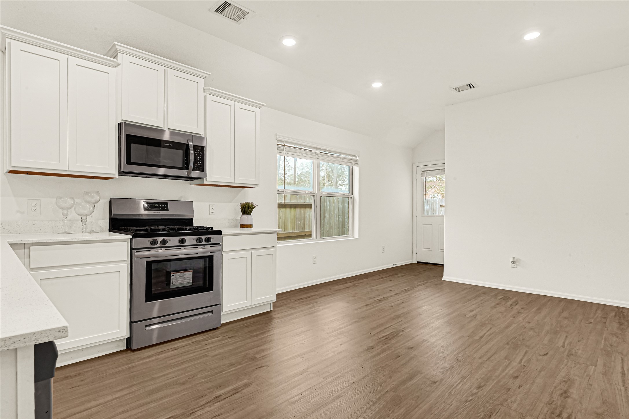 2010 Ballesteros Street Crosby, TX 77532 - Photo 6 of 24 a kitchen with granite countertop a stove and a microwave