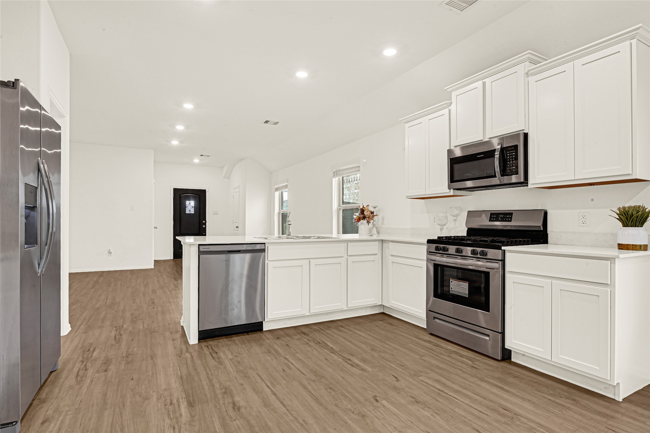 2010 Ballesteros Street Crosby, TX 77532 - Photo 7 of 24 a kitchen with granite countertop a sink and steel appliances