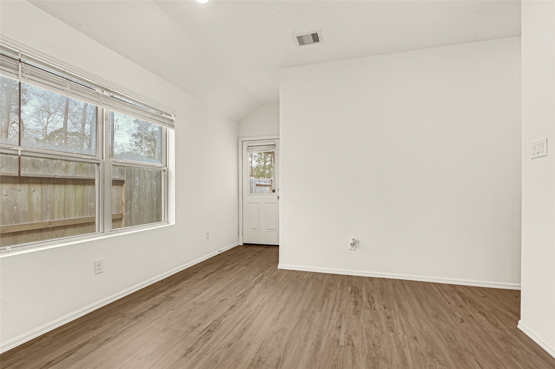 2010 Ballesteros Street Crosby, TX 77532 - Photo 10 of 24 an empty room with wooden floor and windows
