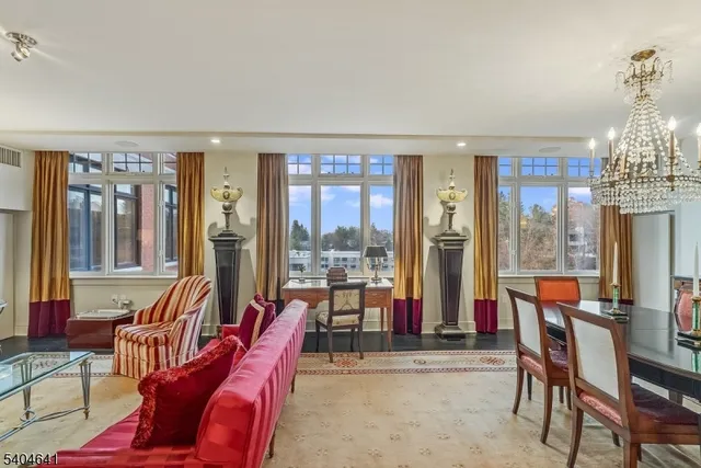 a view of a dining room with furniture large windows and wooden floor