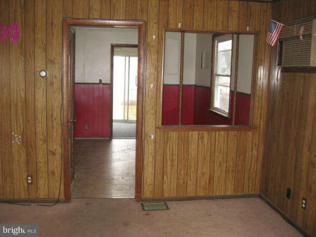 8232 Cornwall Road Baltimore, MD 21222 - Photo 8 of 14 a view of a hallway with wooden shelves