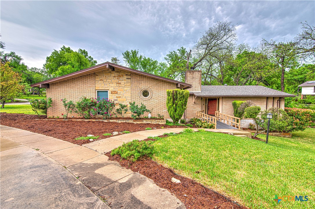 a front view of house with yard and green space