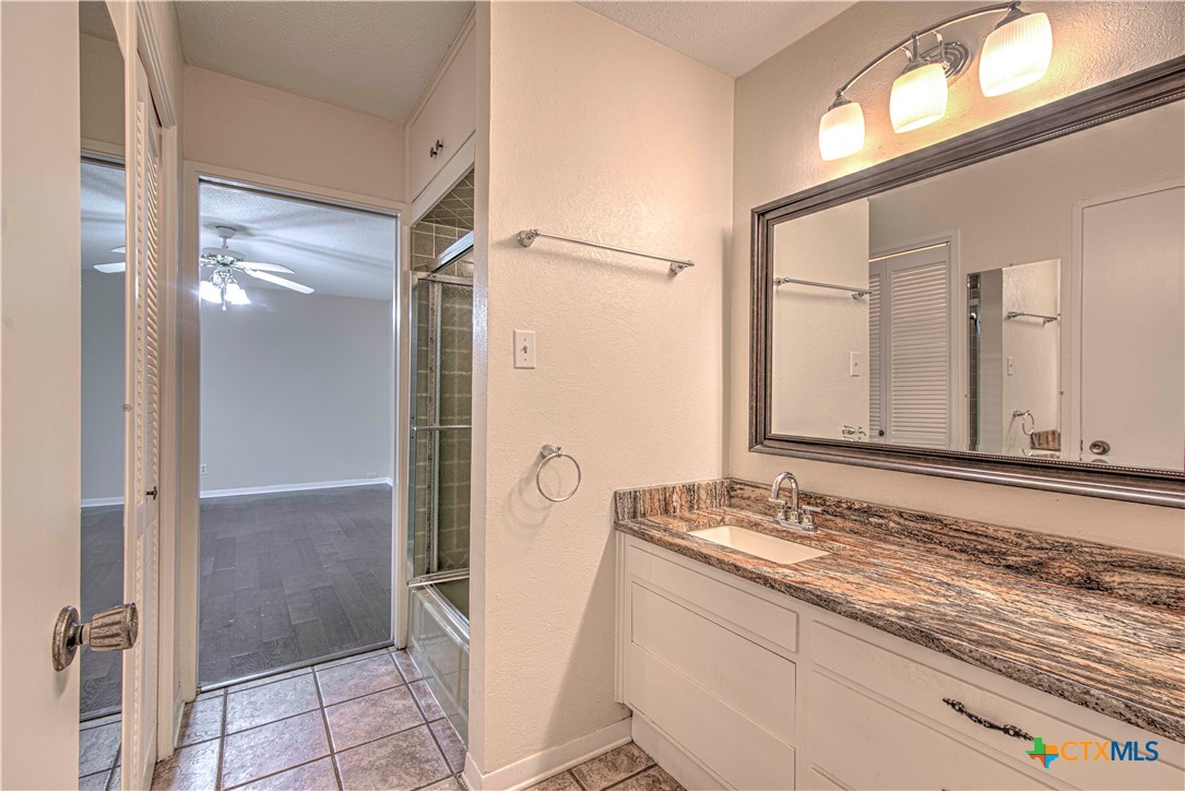2701 Wren Circle Temple, TX 76502 - Photo 26 of 48 a bathroom with a granite countertop sink mirror and shower