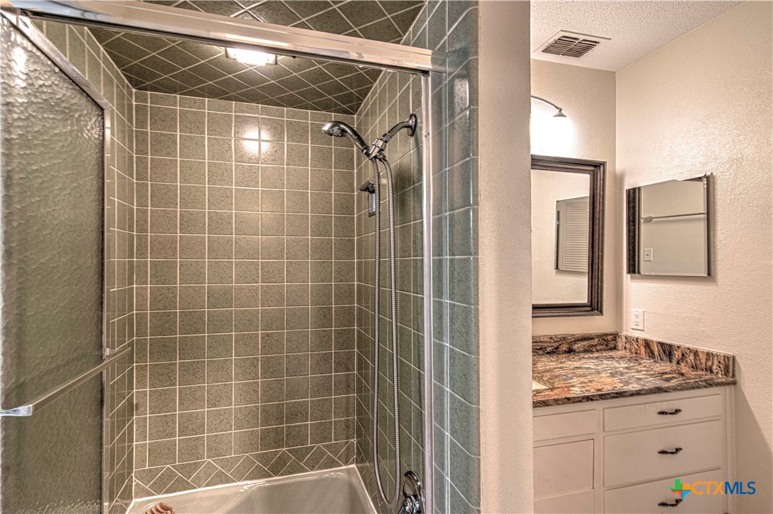 2701 Wren Circle Temple, TX 76502 - Photo 28 of 48 a bathroom with a granite countertop sink a mirror and shower