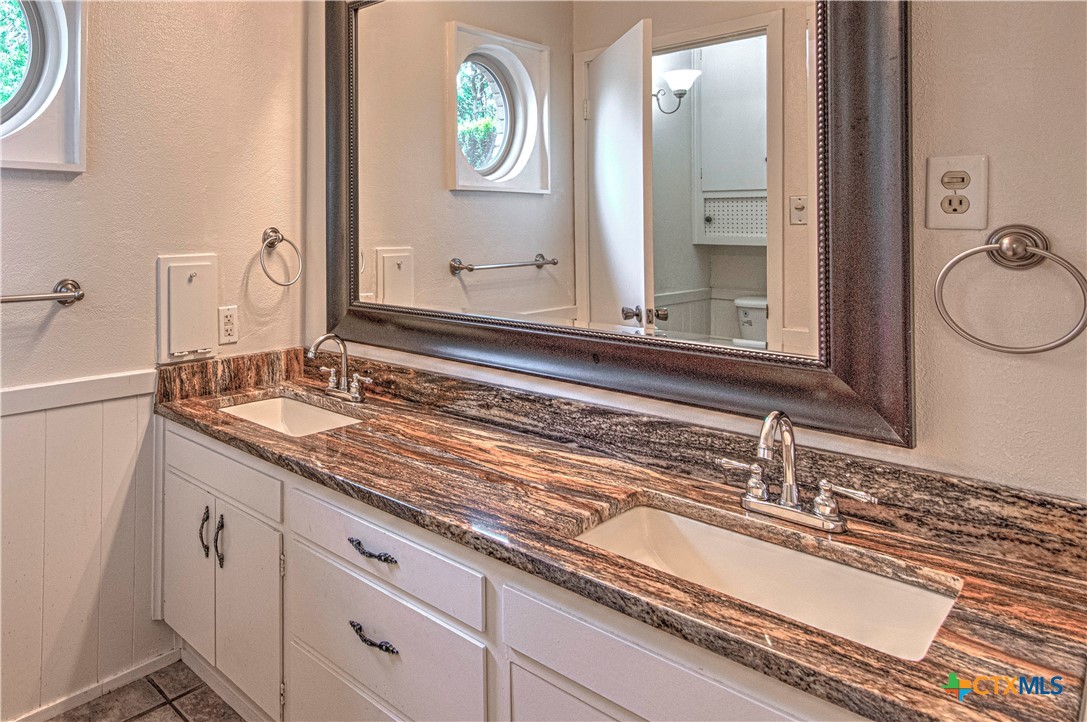 2701 Wren Circle Temple, TX 76502 - Photo 39 of 48 a bathroom with a granite countertop sink and a mirror