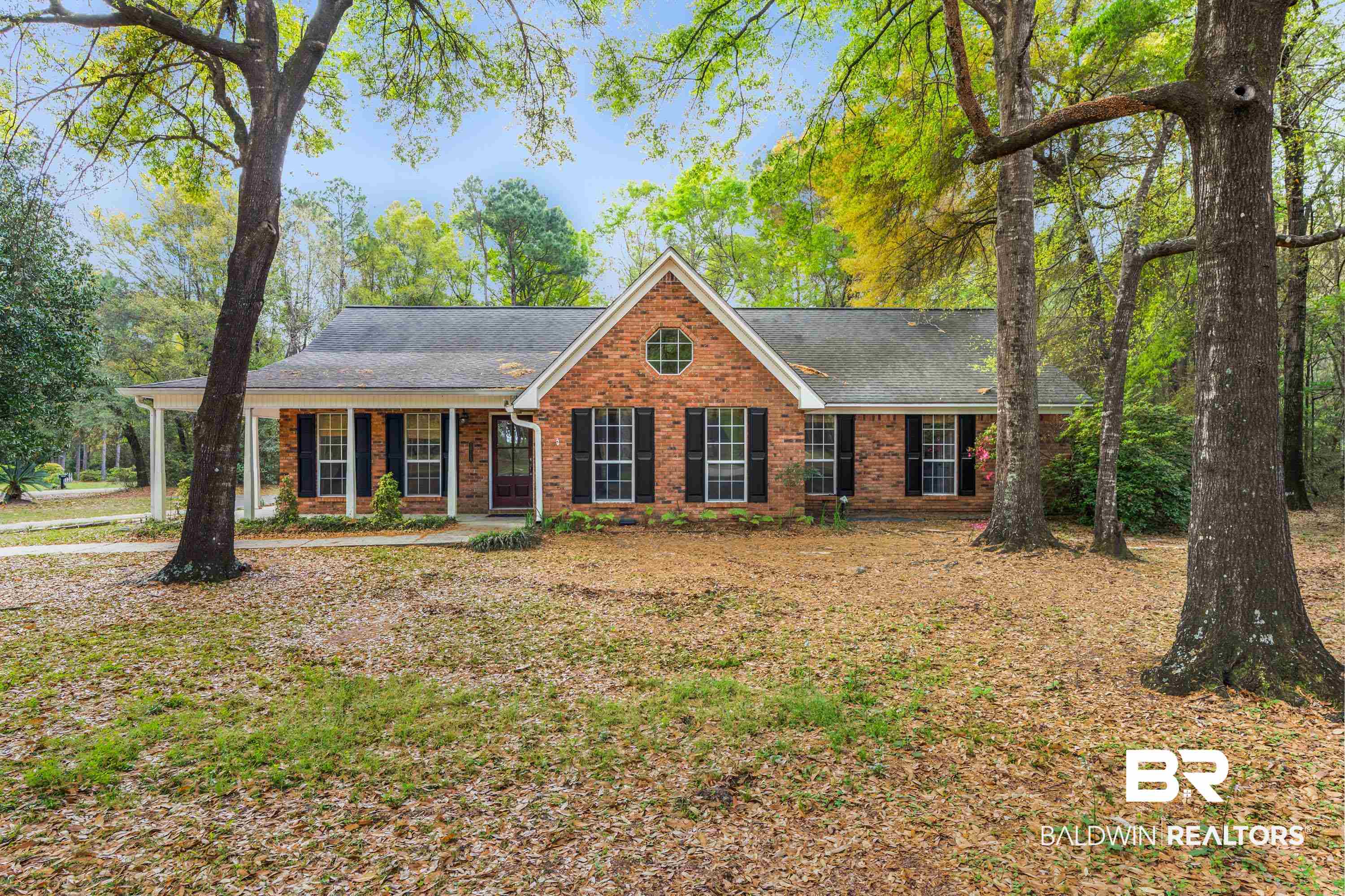 10140 Lakeview Road Bay Minette, AL 36507 - Photo 3 of 35 View of front of home featuring brick siding, covered porch, and roof with shingles