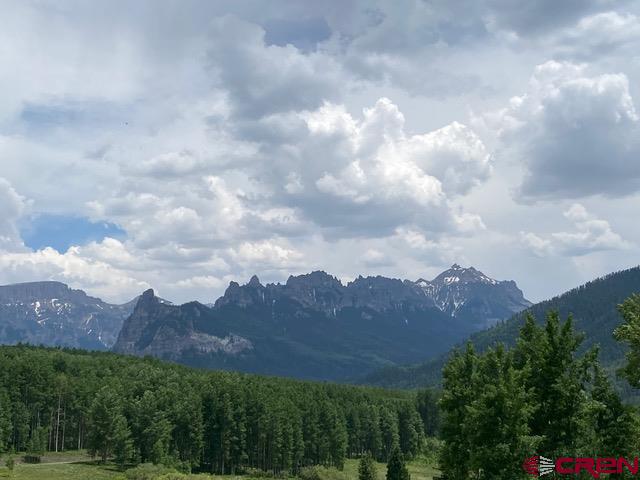 an aerial view of residential house and mountains in the background