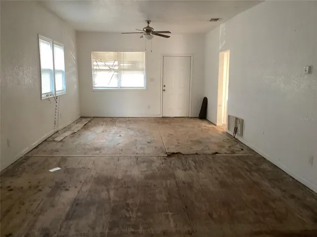 an empty room with windows and closet