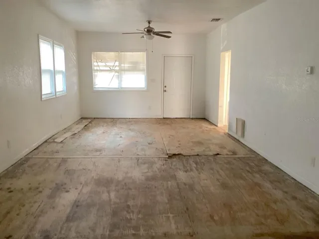 an empty room with windows and closet