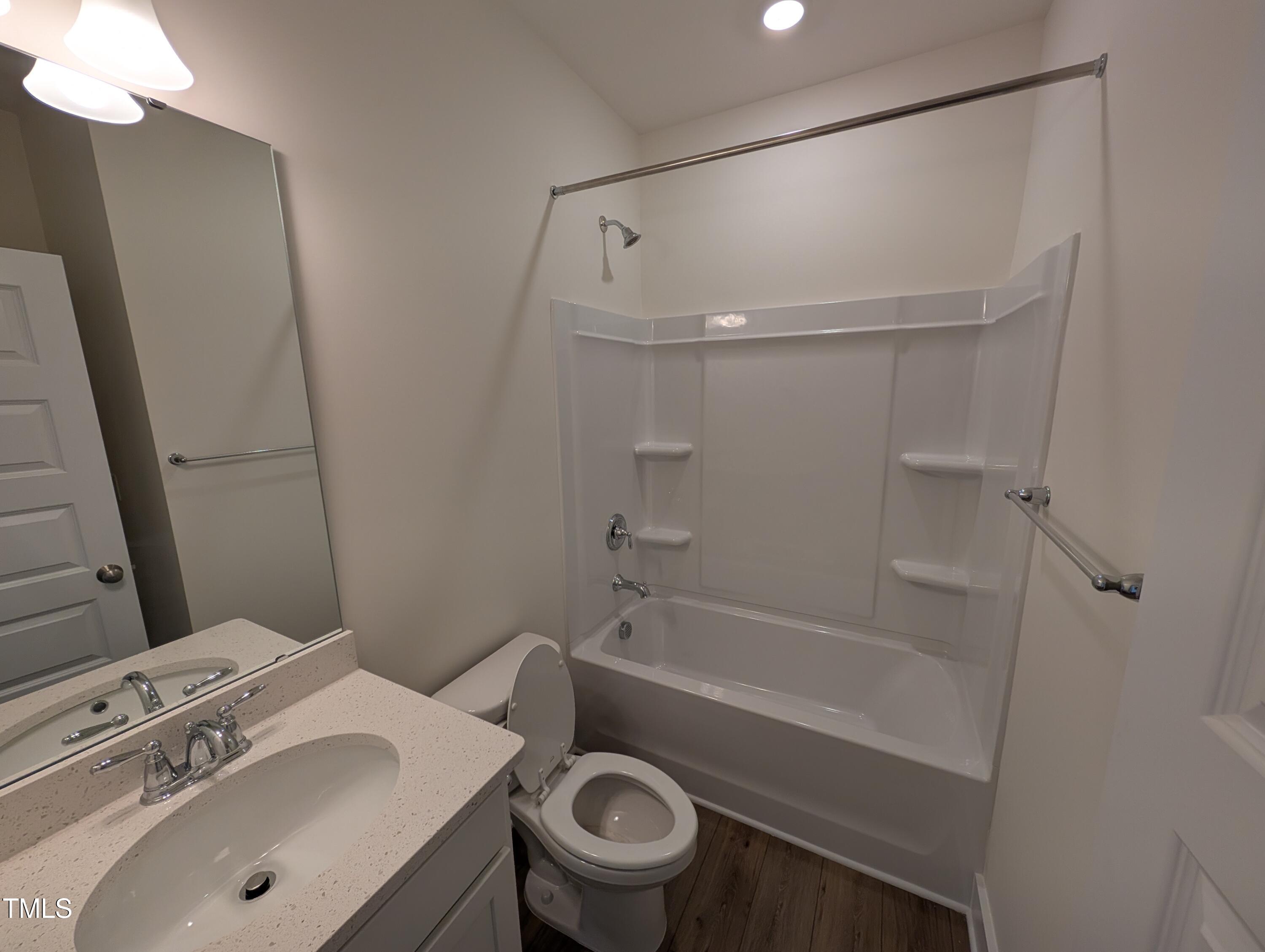 266 Weddington Way Benson, NC 27504 - Photo 14 of 35 a bathroom with a sink a toilet and shower