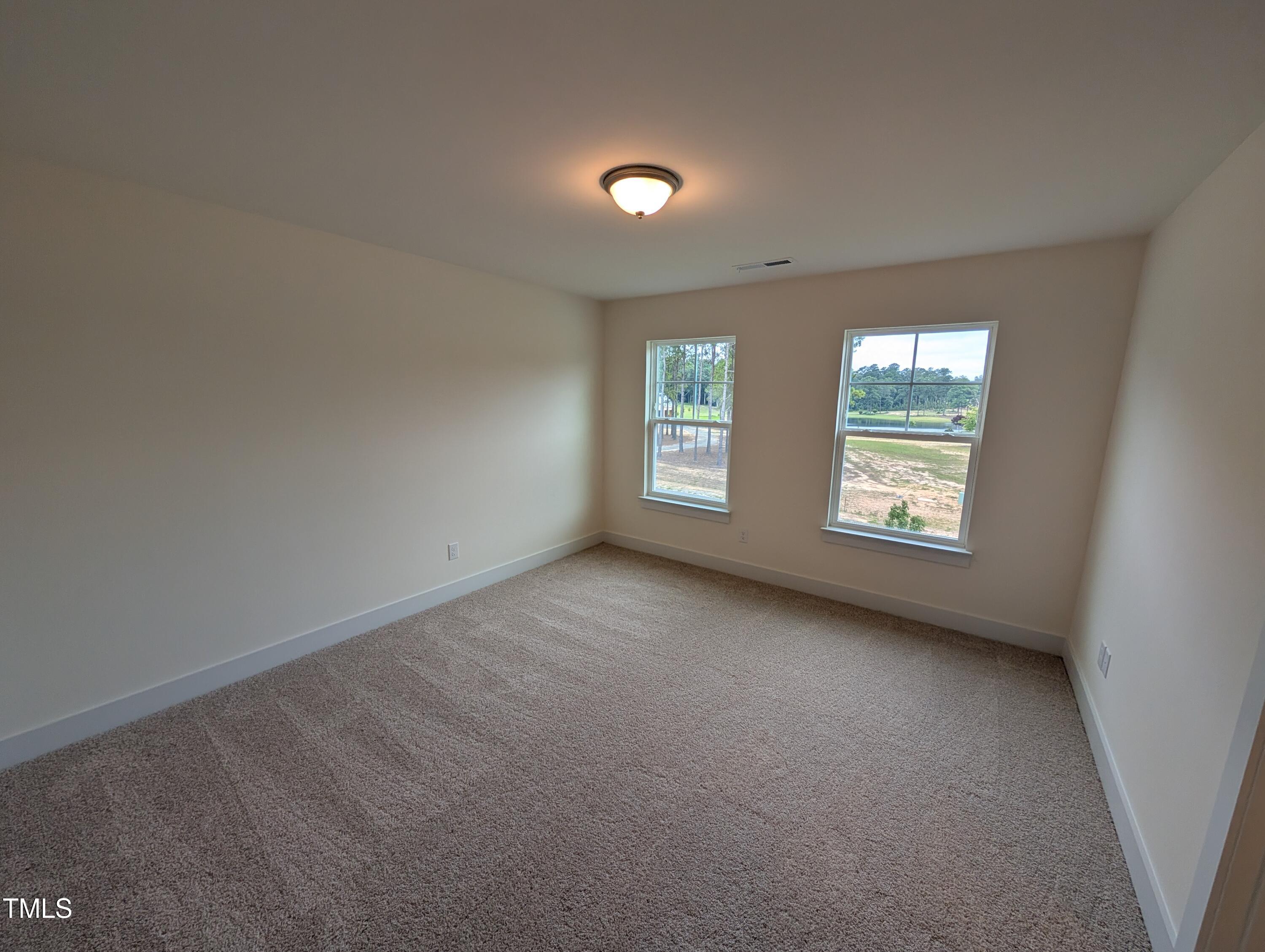 266 Weddington Way Benson, NC 27504 - Photo 19 of 35 an empty room with windows