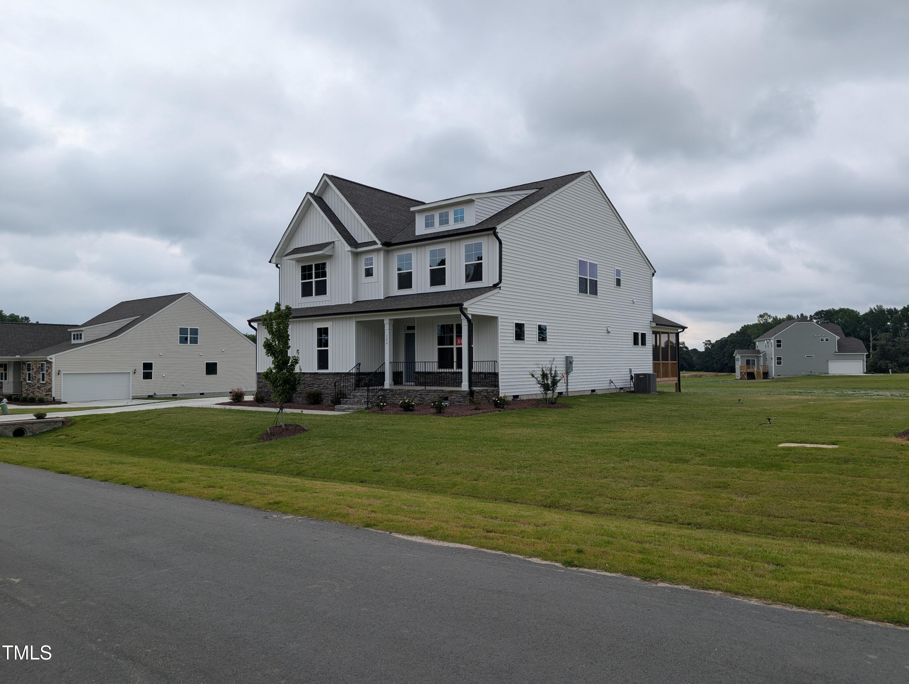 266 Weddington Way Benson, NC 27504 - Photo 2 of 35 a front view of a house with a garden
