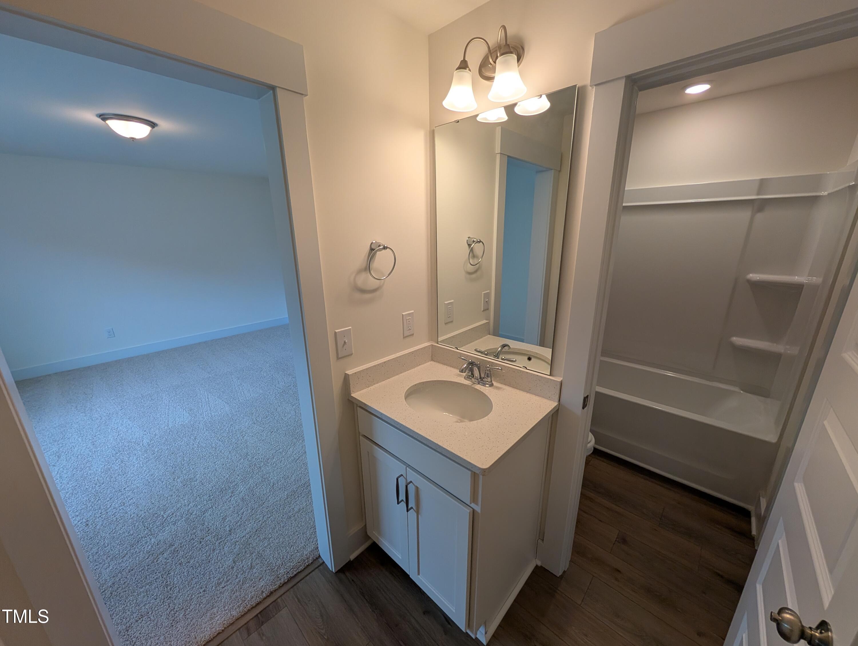 266 Weddington Way Benson, NC 27504 - Photo 22 of 35 a bathroom with a sink a mirror and a shower