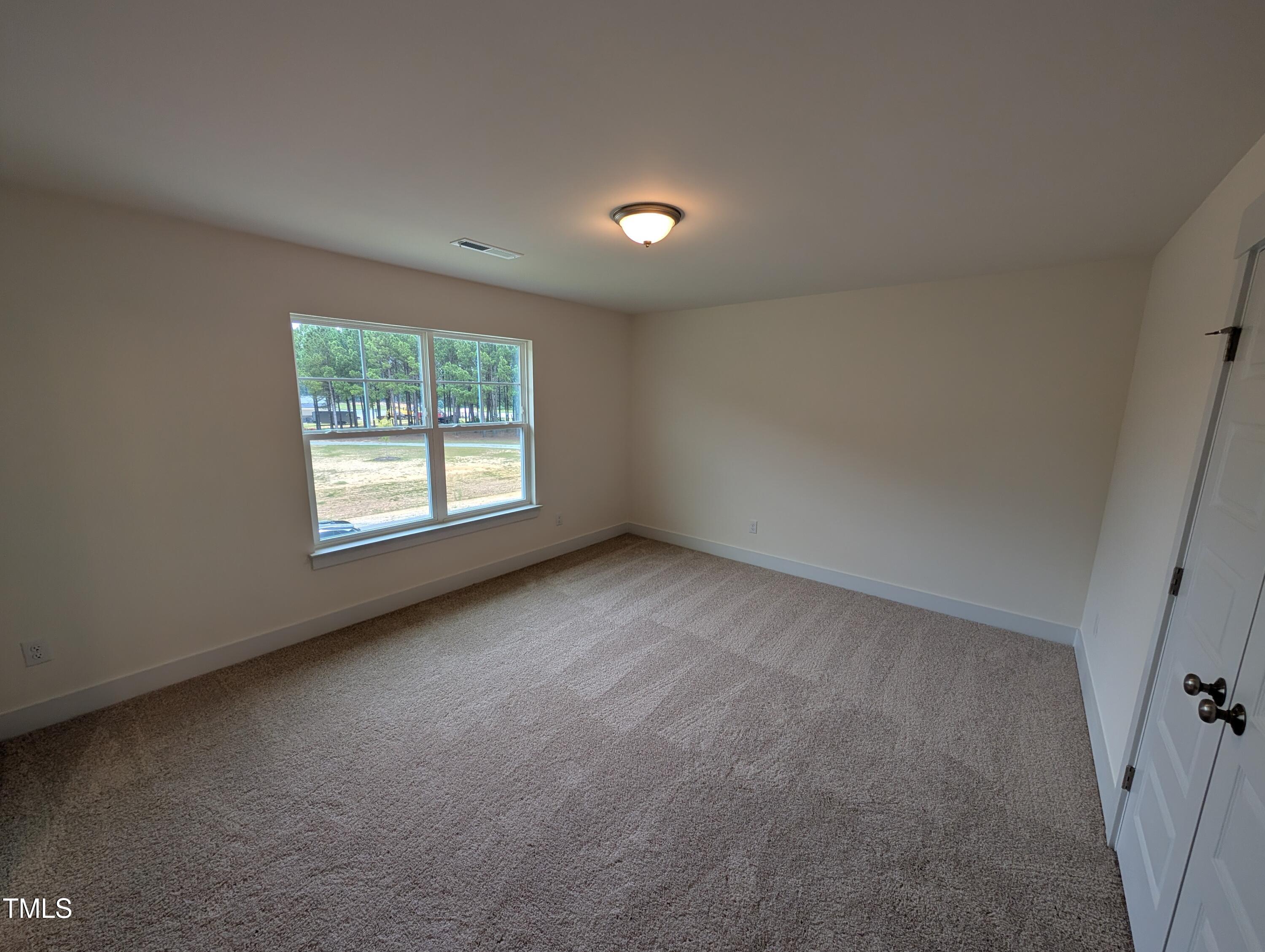 266 Weddington Way Benson, NC 27504 - Photo 23 of 35 an empty room with windows