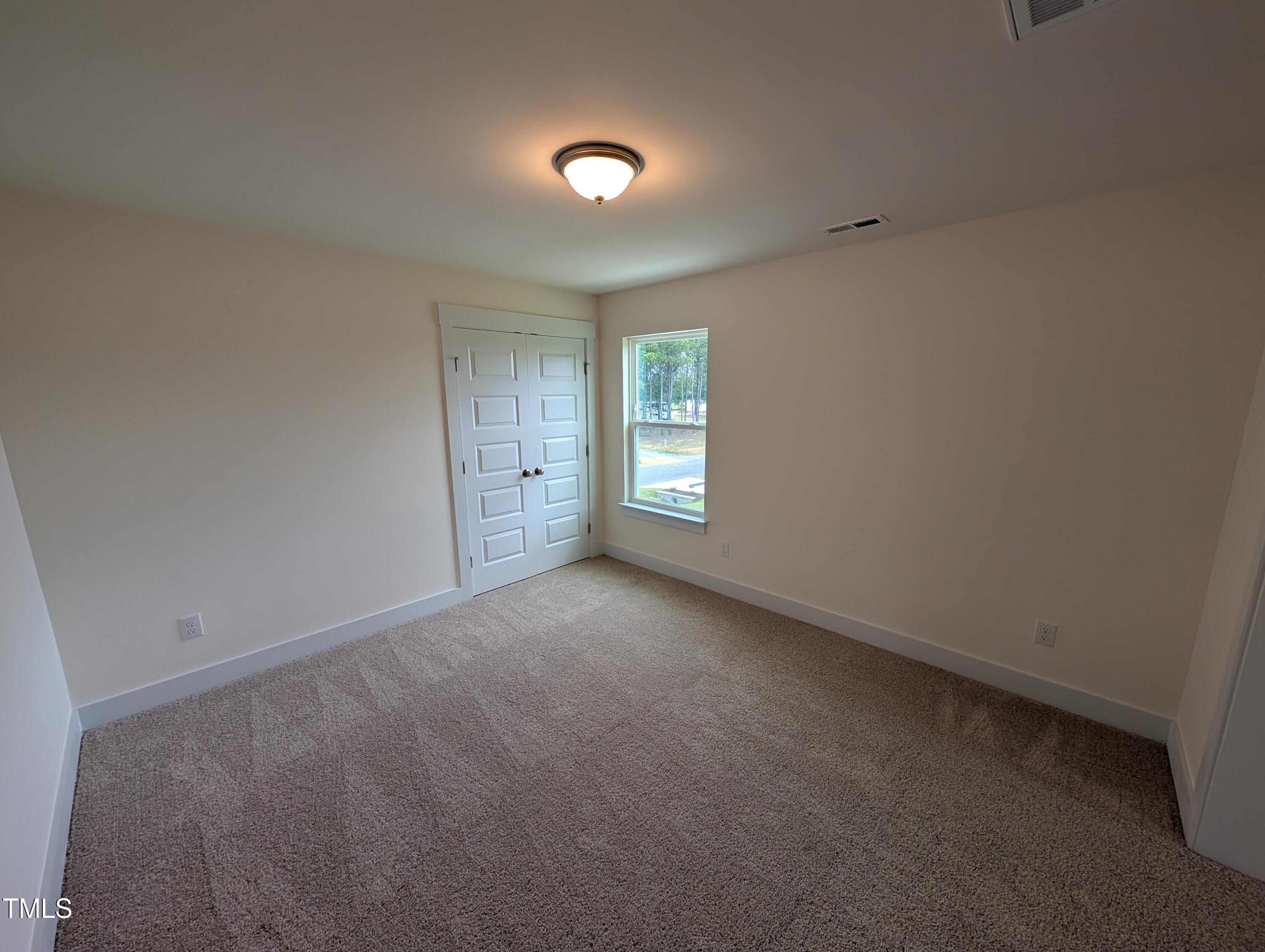 266 Weddington Way Benson, NC 27504 - Photo 27 of 35 a view of an empty room and window