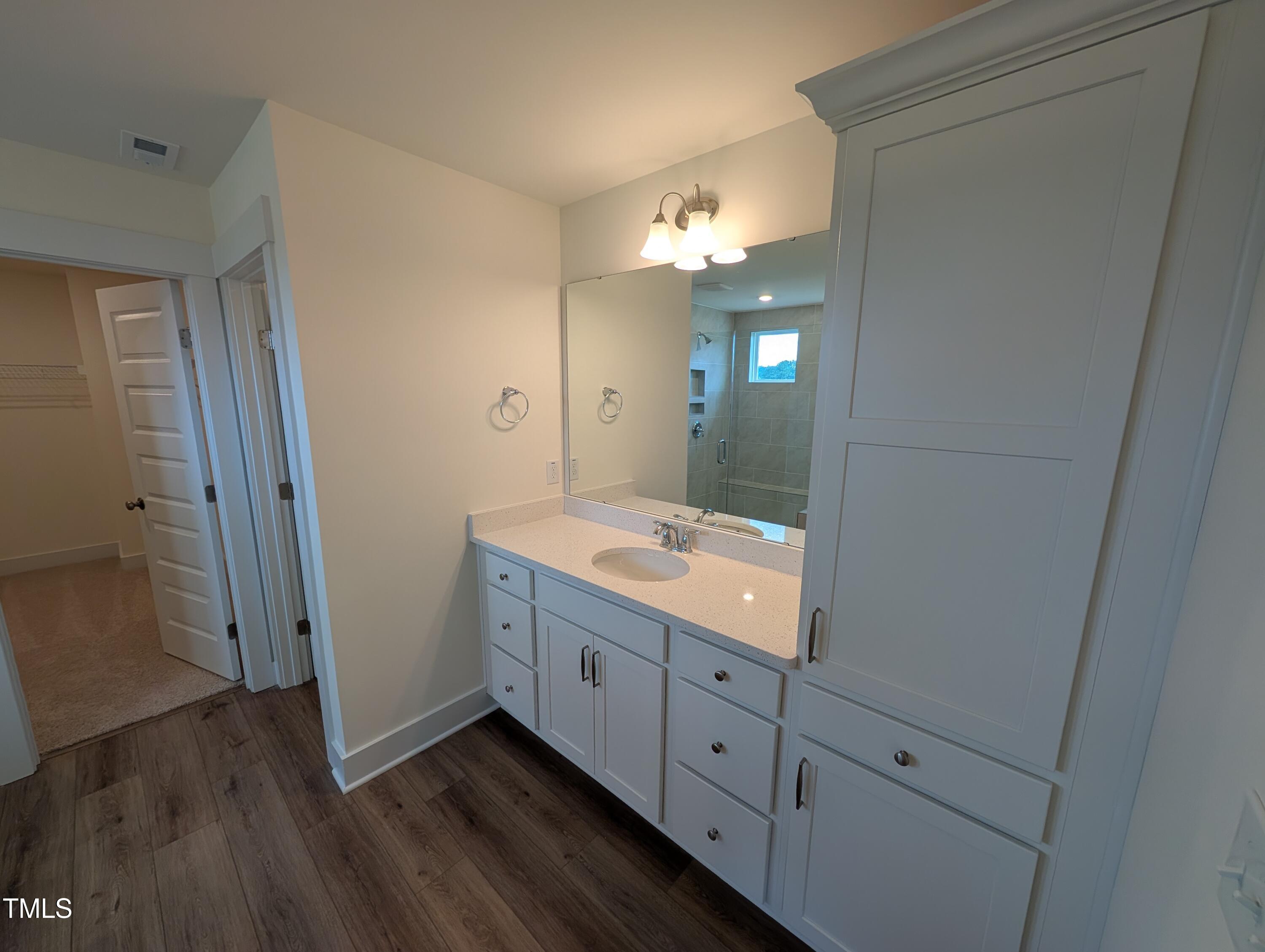 266 Weddington Way Benson, NC 27504 - Photo 28 of 35 a bathroom with a double vanity sink and mirror