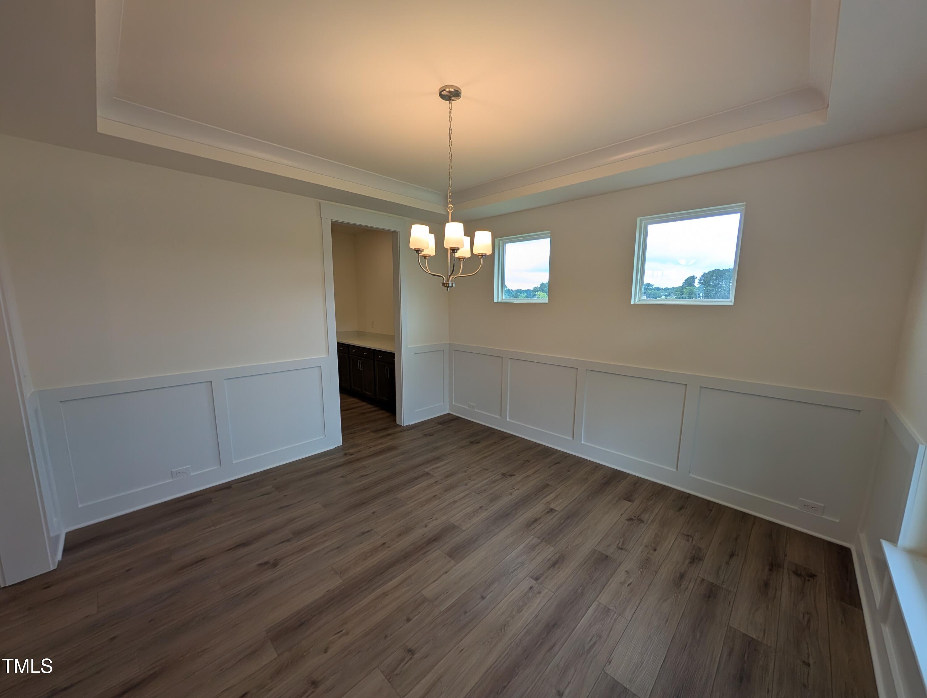 266 Weddington Way Benson, NC 27504 - Photo 4 of 35 an empty room with wooden floor and windows