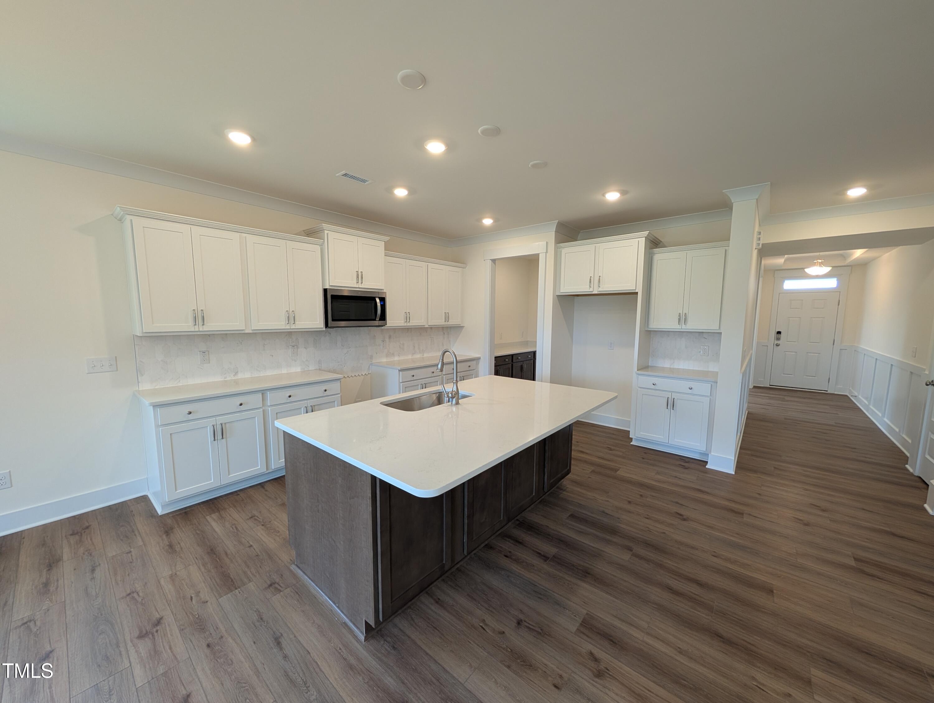 266 Weddington Way Benson, NC 27504 - Photo 9 of 35 a kitchen with a sink stainless steel appliances and white cabinets