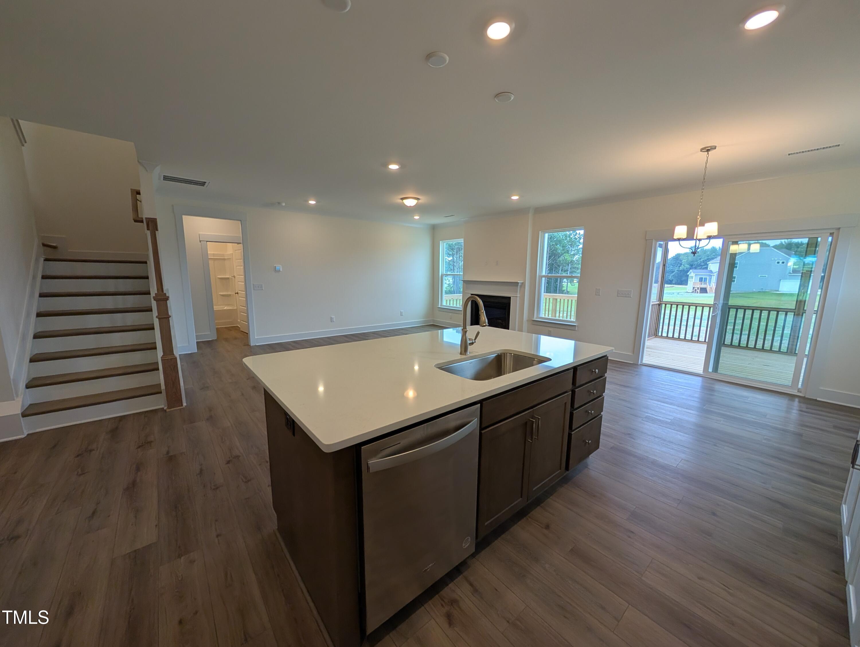 266 Weddington Way Benson, NC 27504 - Photo 10 of 35 a large kitchen with a center island wooden floor and living room