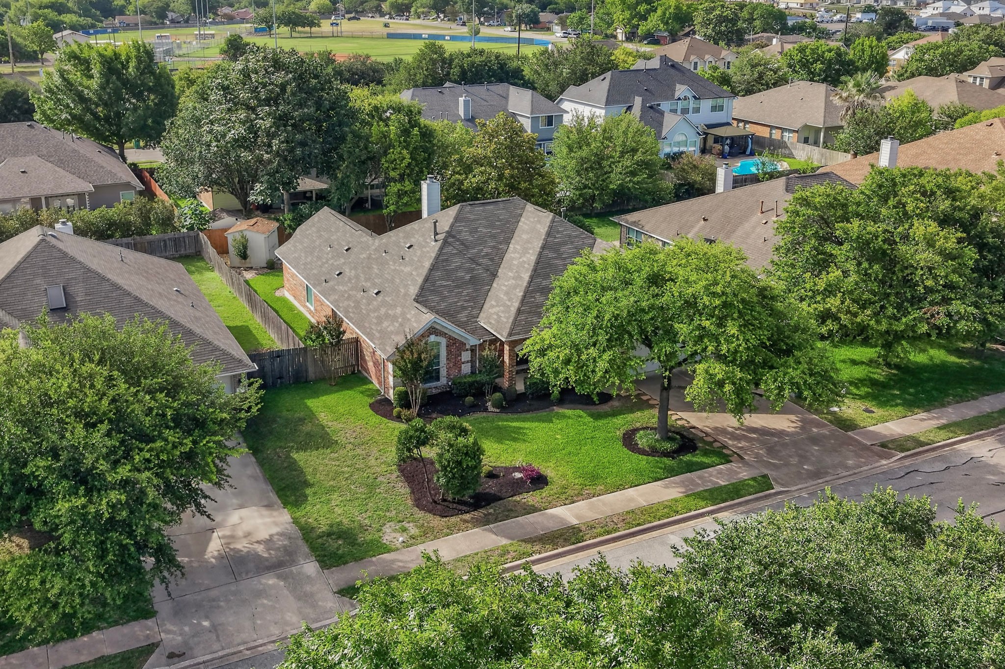 905 Victoria Ridge Drive Pflugerville, TX 78660 - Photo 31 of 32 An inviting front lawn and well-maintained exterior enhance this charming suburban home's curb appeal.